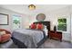 Main bedroom with grey carpet, a dark grey headboard, and orange pillows at 805 Iowa St, Indianapolis, IN 46203