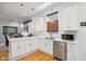 Modern kitchen with white cabinets, stainless steel appliances and hardwood floors at 805 Iowa St, Indianapolis, IN 46203