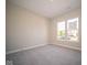 Bright bedroom with neutral walls and carpet, featuring a window with a view at 7936 Beaumont Green Pl, Indianapolis, IN 46250