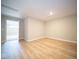 Bright bonus room with light wood flooring and access to another room at 7936 Beaumont Green Pl, Indianapolis, IN 46250