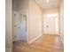 Light and airy entryway with wood-look flooring and access to other rooms at 7936 Beaumont Green Pl, Indianapolis, IN 46250