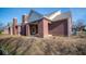 Brick house with a back patio and landscaping at 7936 Beaumont Green Pl, Indianapolis, IN 46250