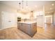 Modern kitchen with white cabinets, island, and stainless steel appliances at 7936 Beaumont Green Pl, Indianapolis, IN 46250