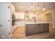Modern kitchen with white cabinets and a large island at 7936 Beaumont Green Pl, Indianapolis, IN 46250