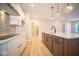 Modern kitchen with an island, white cabinets and hardwood floors at 7936 Beaumont Green Pl, Indianapolis, IN 46250