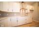 Modern kitchen with white cabinets, quartz countertops, and a vent hood at 7936 Beaumont Green Pl, Indianapolis, IN 46250