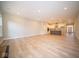 Open living room with kitchen and dining area views, hardwood floors at 7936 Beaumont Green Pl, Indianapolis, IN 46250