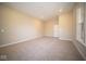 Spacious basement room with neutral wall paint and carpeted floor at 7942 Beaumont Green Pl, Indianapolis, IN 46250