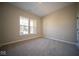 Spacious bedroom with neutral carpeting and large window providing natural light at 7942 Beaumont Green Pl, Indianapolis, IN 46250