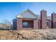 Brick house exterior with covered patio and partially landscaped yard at 7942 Beaumont Green Pl, Indianapolis, IN 46250