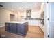Modern kitchen with white cabinets and large island at 7942 Beaumont Green Pl, Indianapolis, IN 46250