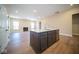 Large kitchen island with dark cabinets and quartz countertop at 7942 Beaumont Green Pl, Indianapolis, IN 46250