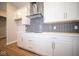 Modern kitchen with white cabinets and gray brick backsplash at 7942 Beaumont Green Pl, Indianapolis, IN 46250