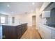 Modern kitchen features a large island, stainless steel appliances, and dark wood cabinets at 7942 Beaumont Green Pl, Indianapolis, IN 46250