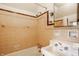 Retro-styled bathroom with pink tile, white sink, and a shower at 6463 N Illinois N St, Indianapolis, IN 46260