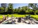 Large stone patio with fire pit, seating area, and lush landscaping at 6463 N Illinois N St, Indianapolis, IN 46260