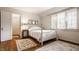 Serene bedroom with hardwood floors, white bedding, and ample natural light at 6463 N Illinois N St, Indianapolis, IN 46260