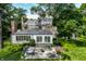 Brick house with sunroom and patio, surrounded by mature trees at 6463 N Illinois N St, Indianapolis, IN 46260