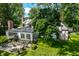 Brick house with sunroom and patio, surrounded by mature trees at 6463 N Illinois N St, Indianapolis, IN 46260
