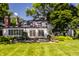 Whitewashed brick home with a sunroom and manicured lawn at 6463 N Illinois N St, Indianapolis, IN 46260