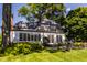 Brick home with a sunroom, stone patio, and green lawn at 6463 N Illinois N St, Indianapolis, IN 46260