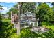 Brick house with sunroom and patio, surrounded by mature trees at 6463 N Illinois N St, Indianapolis, IN 46260