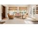 Bright sunroom with wicker shades, leather chairs, and French doors leading to the backyard at 6463 N Illinois N St, Indianapolis, IN 46260