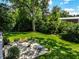 Spacious backyard with patio, fire pit, and lush landscaping at 6463 N Illinois N St, Indianapolis, IN 46260