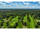 Aerial view of a golf course and surrounding neighborhood, with a city skyline in the distance at 6463 N Illinois N St, Indianapolis, IN 46260