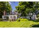 Charming brick home with a sunroom and lush landscaping at 6463 N Illinois N St, Indianapolis, IN 46260
