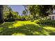 Expansive grassy backyard with mature trees and partial home view at 6463 N Illinois N St, Indianapolis, IN 46260