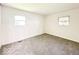 Bright bedroom with grey carpet and two windows at 3720 Breen Dr, Indianapolis, IN 46235