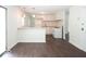 Kitchen boasts white cabinets, gas range and breakfast bar at 3720 Breen Dr, Indianapolis, IN 46235