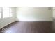 Spacious living room featuring dark hardwood floors and large windows at 3720 Breen Dr, Indianapolis, IN 46235