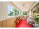 Spacious screened porch with wicker furniture and lake view at 409 W Lakeview Dr, Nineveh, IN 46164