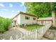 Charming ranch home with a well-maintained yard and white picket fence at 409 W Lakeview Dr, Nineveh, IN 46164
