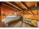 Spacious loft bedroom with wood-beamed ceiling and king-size bed at 409 W Lakeview Dr, Nineveh, IN 46164