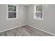 Spacious bedroom with two windows and wood-look floors at 929 Olin Ave, Indianapolis, IN 46222