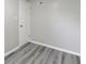 Empty bedroom with one door and wood-look floors at 929 Olin Ave, Indianapolis, IN 46222