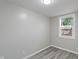 Cozy bedroom with one window and wood-look floors at 929 Olin Ave, Indianapolis, IN 46222