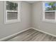 Bright bedroom with two windows and wood-look floors at 929 Olin Ave, Indianapolis, IN 46222