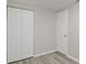Simple bedroom with double doors and wood-look floors at 929 Olin Ave, Indianapolis, IN 46222