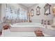 Oval bathtub with ornate gold accents and large window at 8292 S State Road 39 S Rd, Clayton, IN 46118