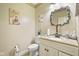 Small bathroom with white vanity, toilet, and decorative wall art at 8292 S State Road 39 S Rd, Clayton, IN 46118