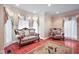 Bright sitting room features hardwood floors, bay windows, and comfortable seating at 8292 S State Road 39 S Rd, Clayton, IN 46118