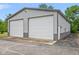 Detached two-car garage with white doors at 8292 S State Road 39 S Rd, Clayton, IN 46118