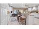 Kitchen features island with seating, white cabinets, and granite countertops at 8292 S State Road 39 S Rd, Clayton, IN 46118