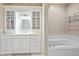 Bathroom with white vanity, bathtub, and glass shower enclosure at 8292 S State Road 39 S Rd, Clayton, IN 46118