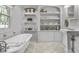Elegant bathroom with soaking tub, built-in shelving, and marble flooring at 2705 S 975 E, Zionsville, IN 46077