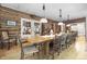 Rustic dining room with a large wooden table and chairs, overlooking kitchen at 2705 S 975 E, Zionsville, IN 46077